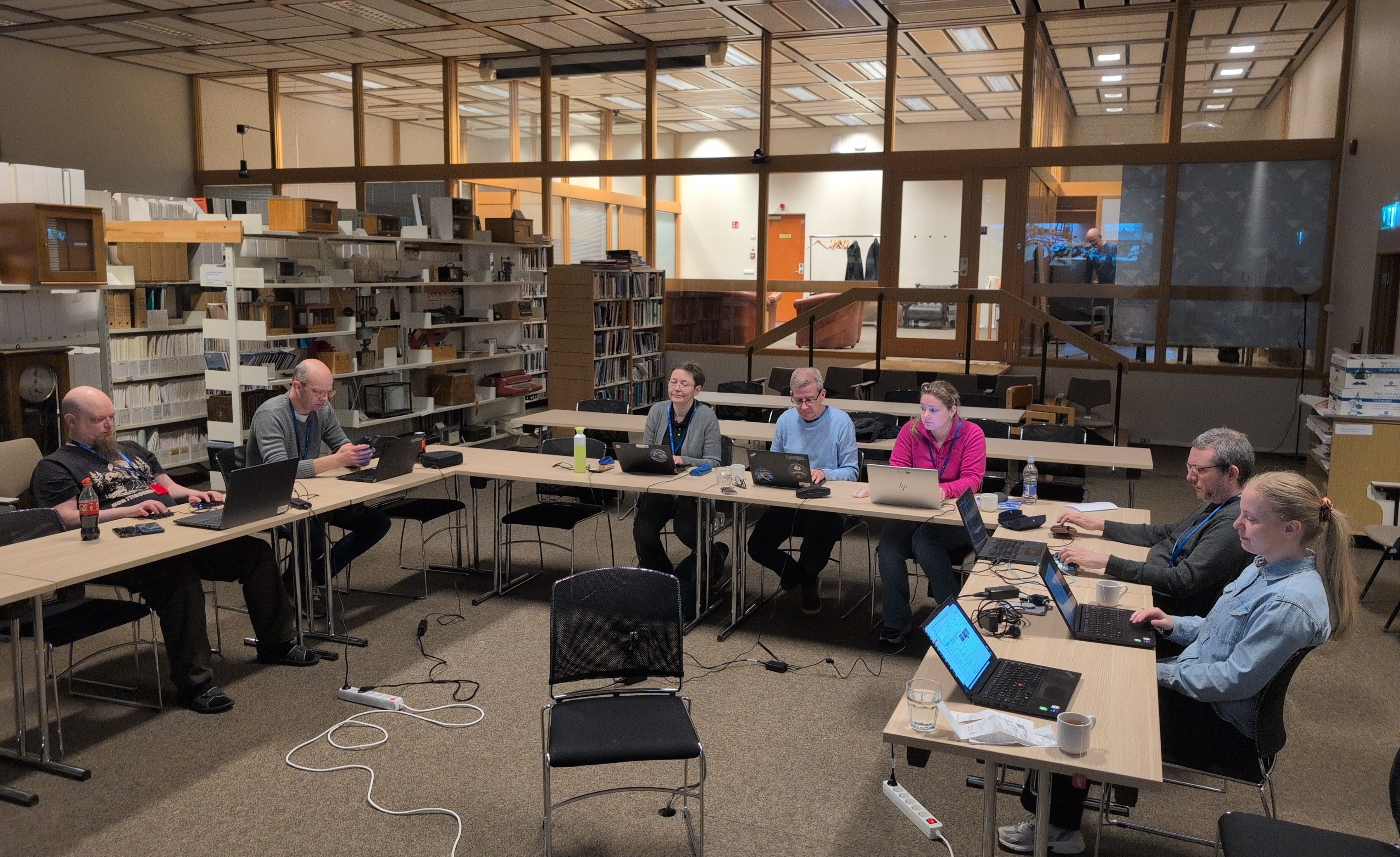 inimesed koosolekut pidamas laudade taga